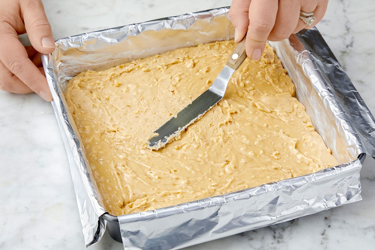 Penuche fudge spread into the prepared pan