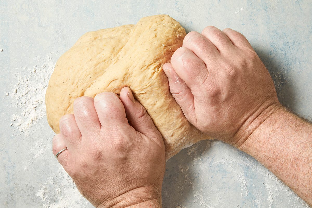 Overhead shot of turn dough onto a floured surface; knead until smooth and elastic 6-8 minutes