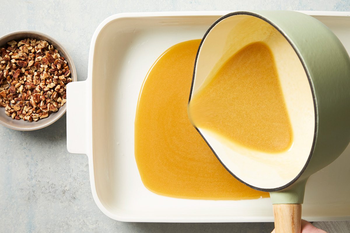 Overhead shot of pour remaining glaze into a greased 13x9-inch baking pan