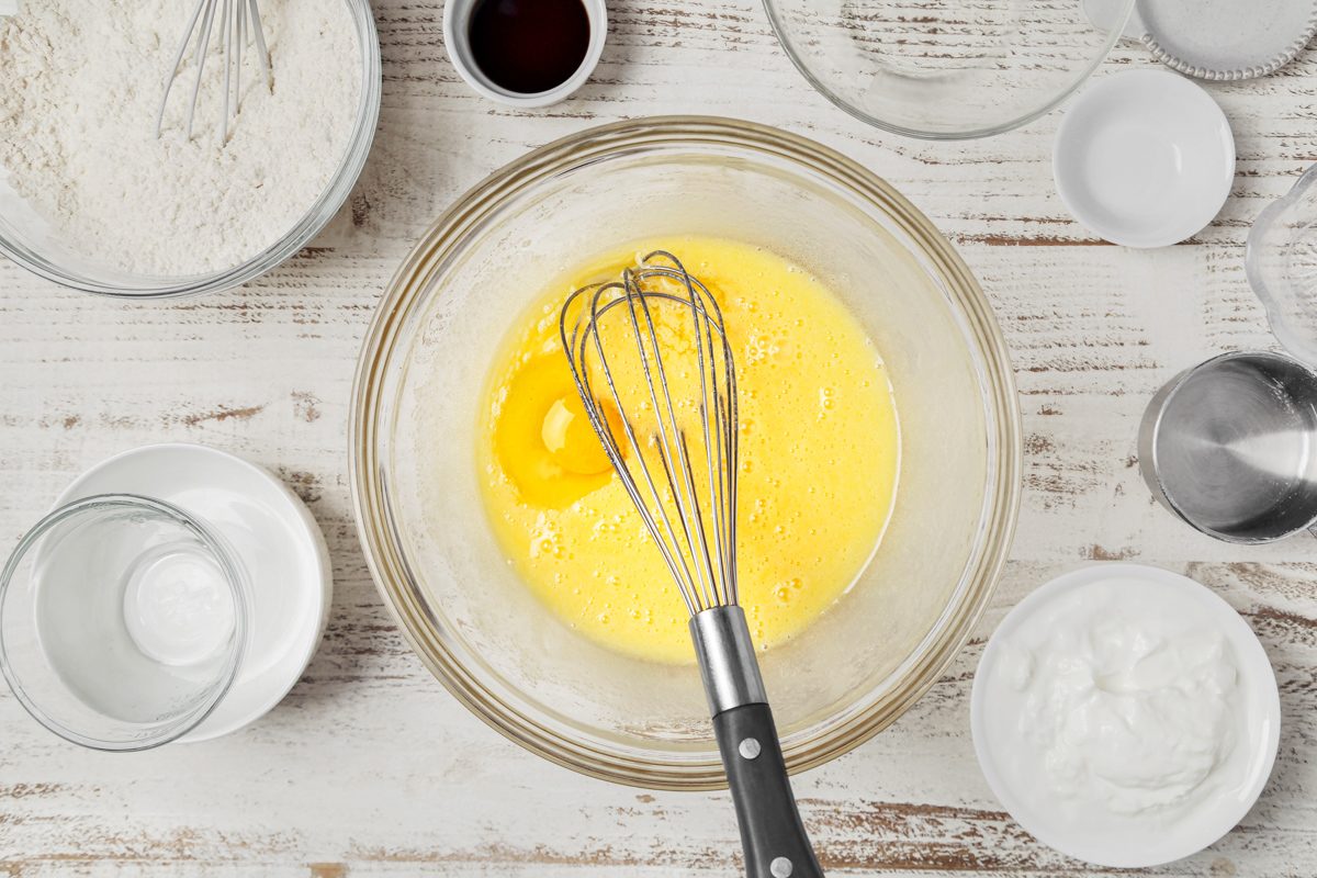 sugar, oil and eggs mixed together in a bowl