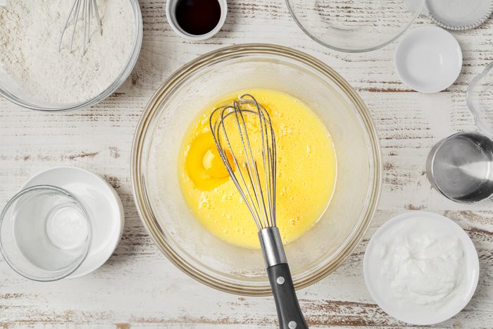 sugar, oil and eggs mixed together in a bowl