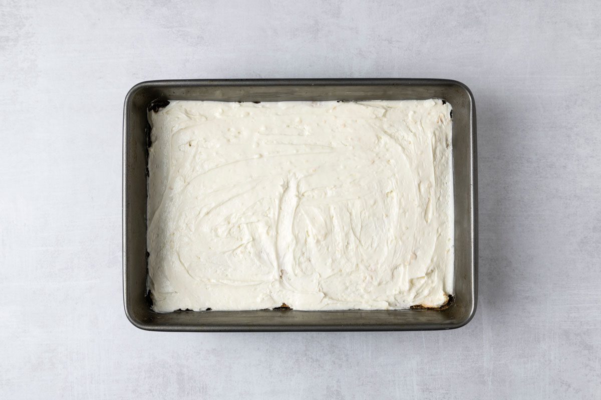 overhead shot of a rectangular baking pan filled with a smooth, creamy substance; the background is a light gray texture