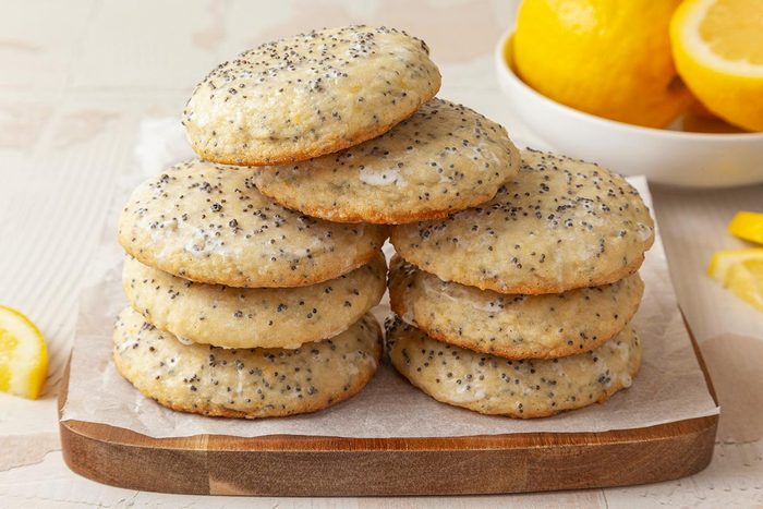 Lemon Poppy Seed Cookies resting on a wooden serving tray lined with parchment paper