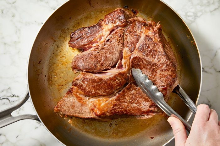 Chuck roast added to pan, seared until deep brown on all sides, 2-3 minutes per side.