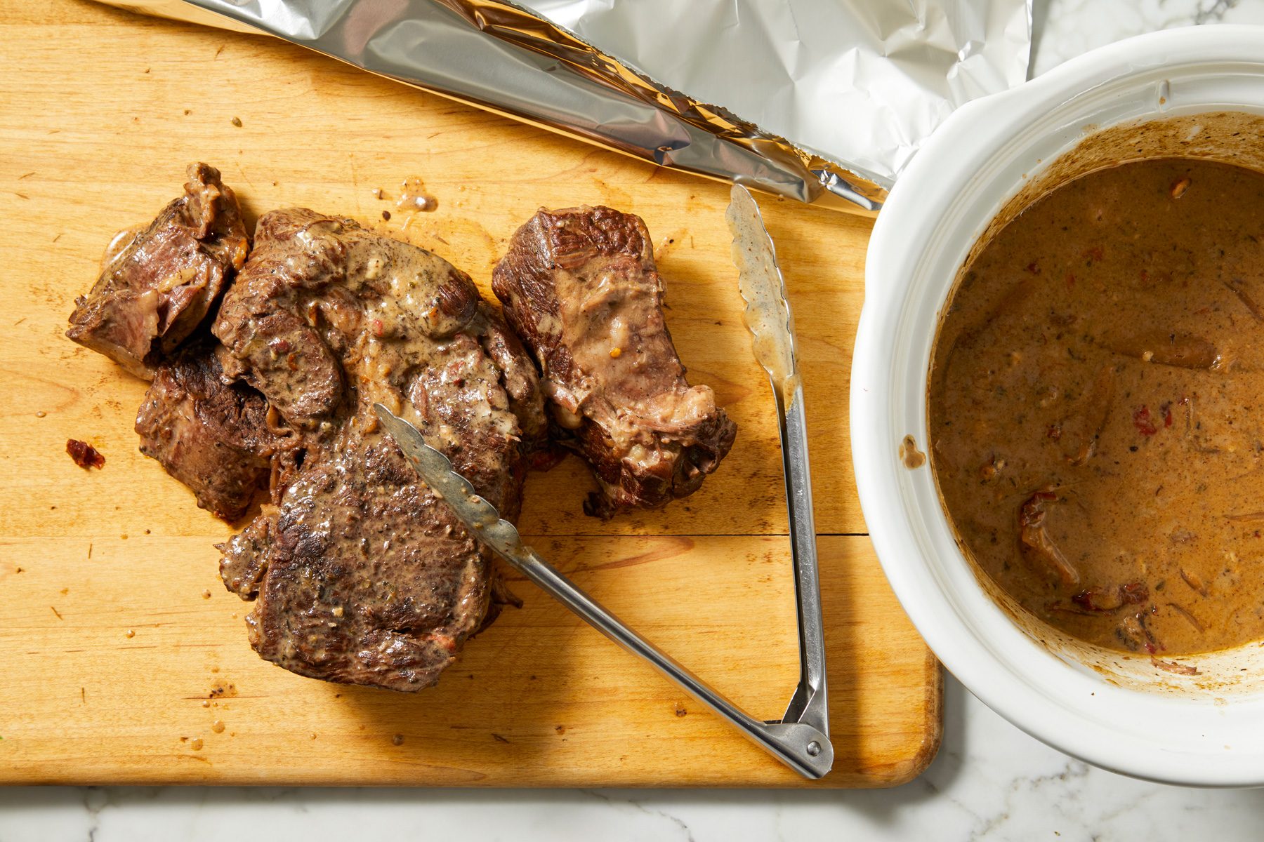 Roast transferred to cutting board, tented with foil.