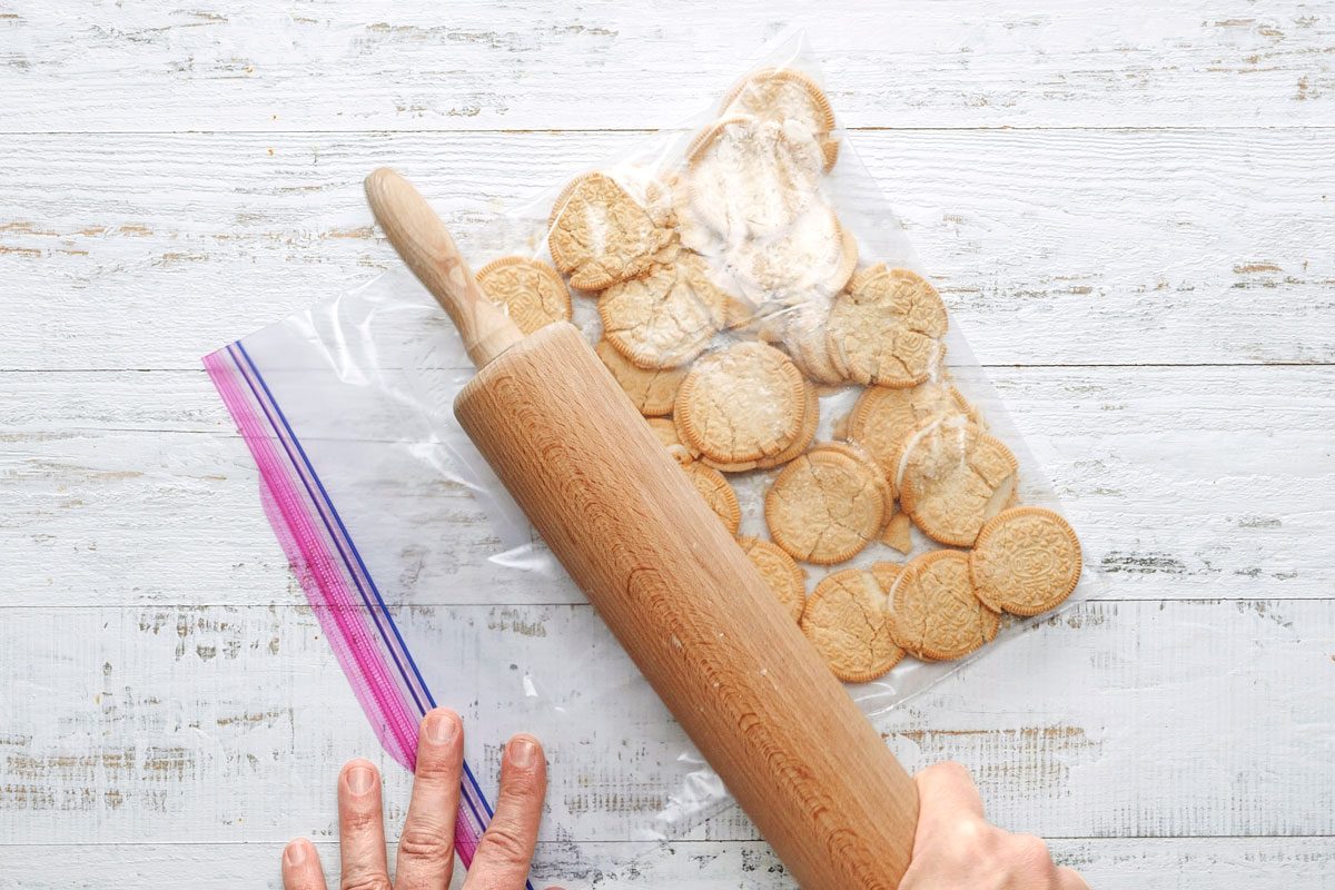 Overhead shot of Finely crush 24 cookies; wooden white surface;