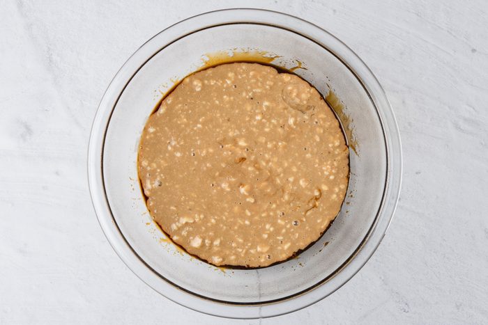 pudding mixture poured into bowl layered with golden syrup and molasses