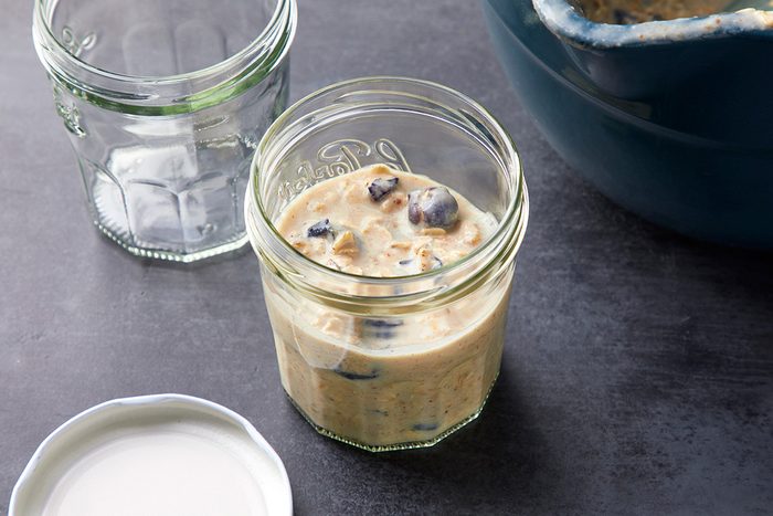 Overhead shot of divide into containers; cover; refrigerate overnight; all set on a dark surface;