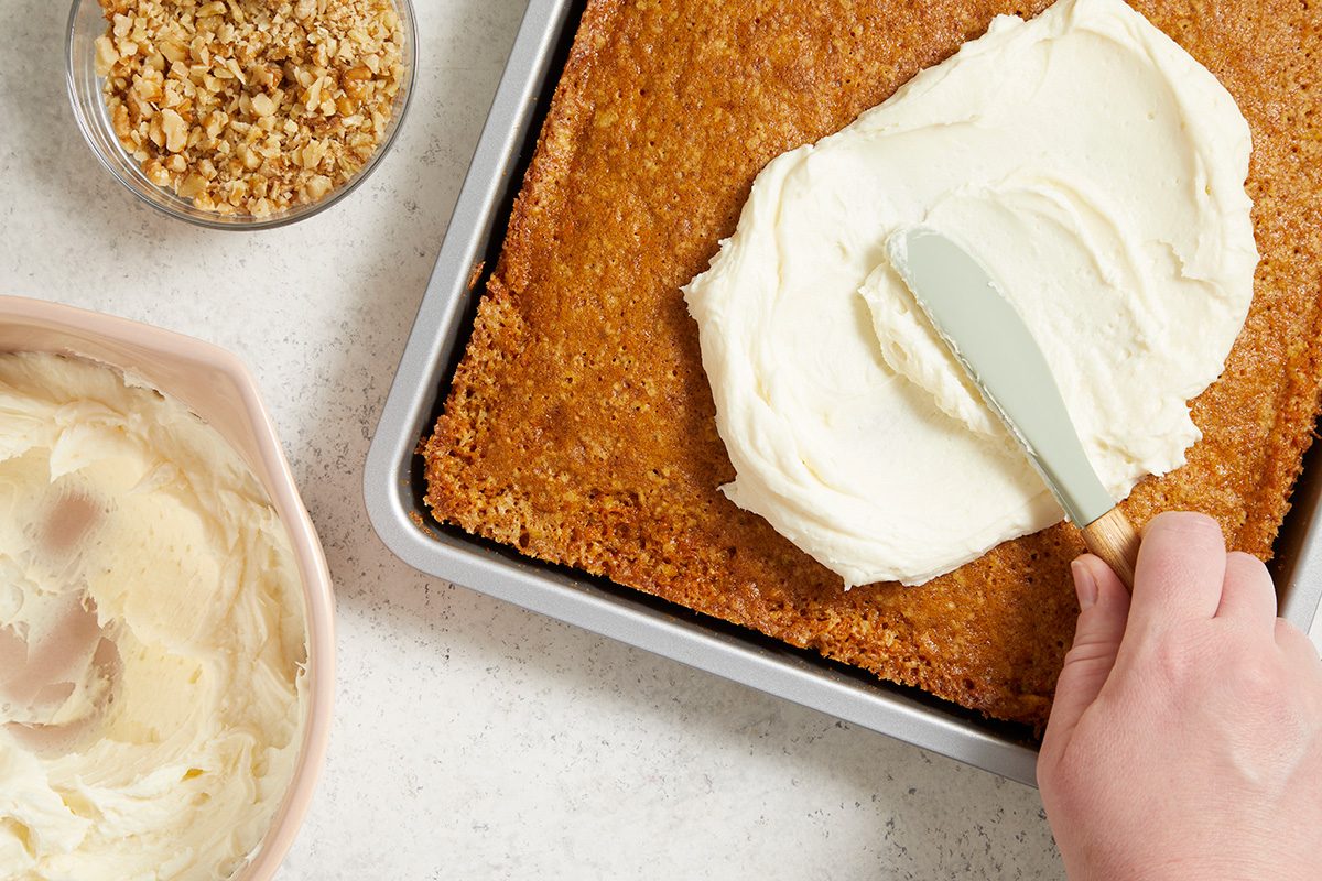 Spread frosting over cake