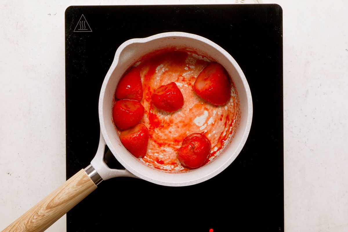 In a saucepan cook strawberries