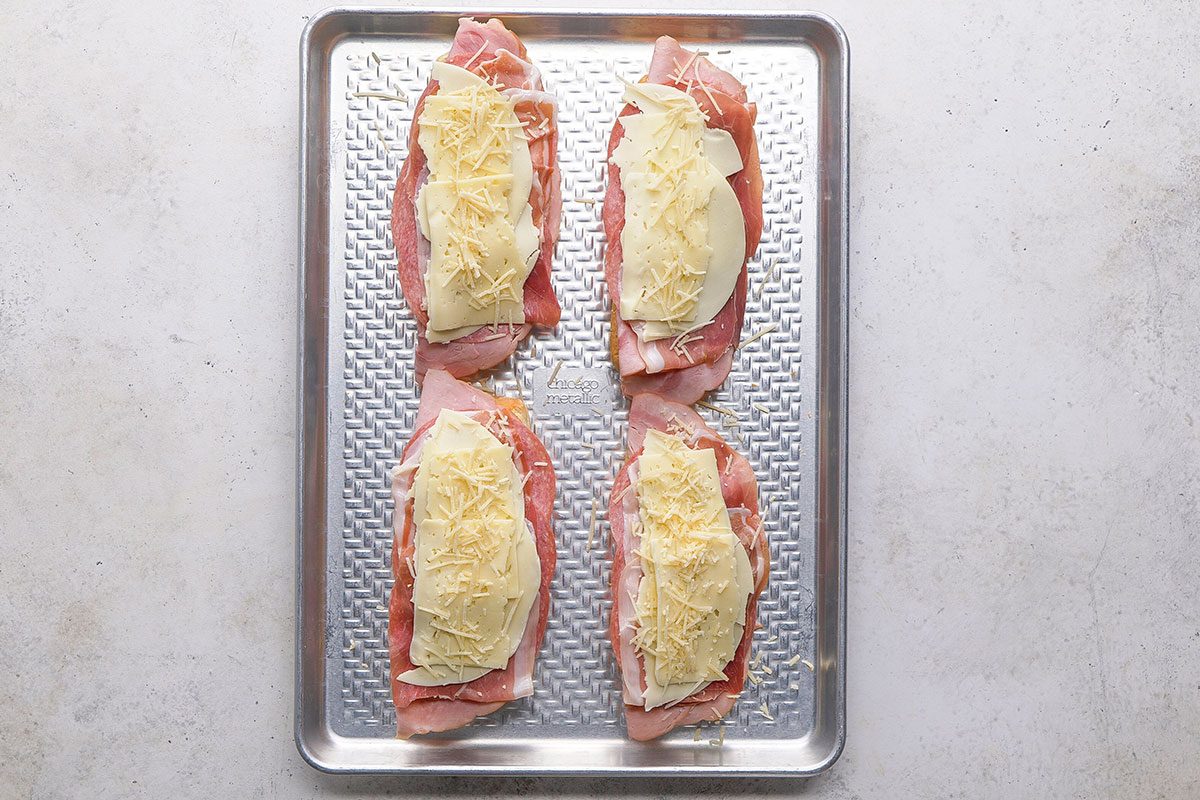 Grinder Sandwich, meat slices topped with some cheese on the toast in eight pieces on a tray