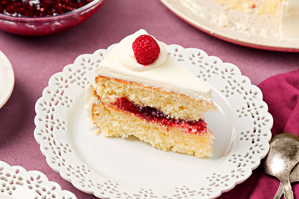 White chocolate rasberry cake slice ready to serve