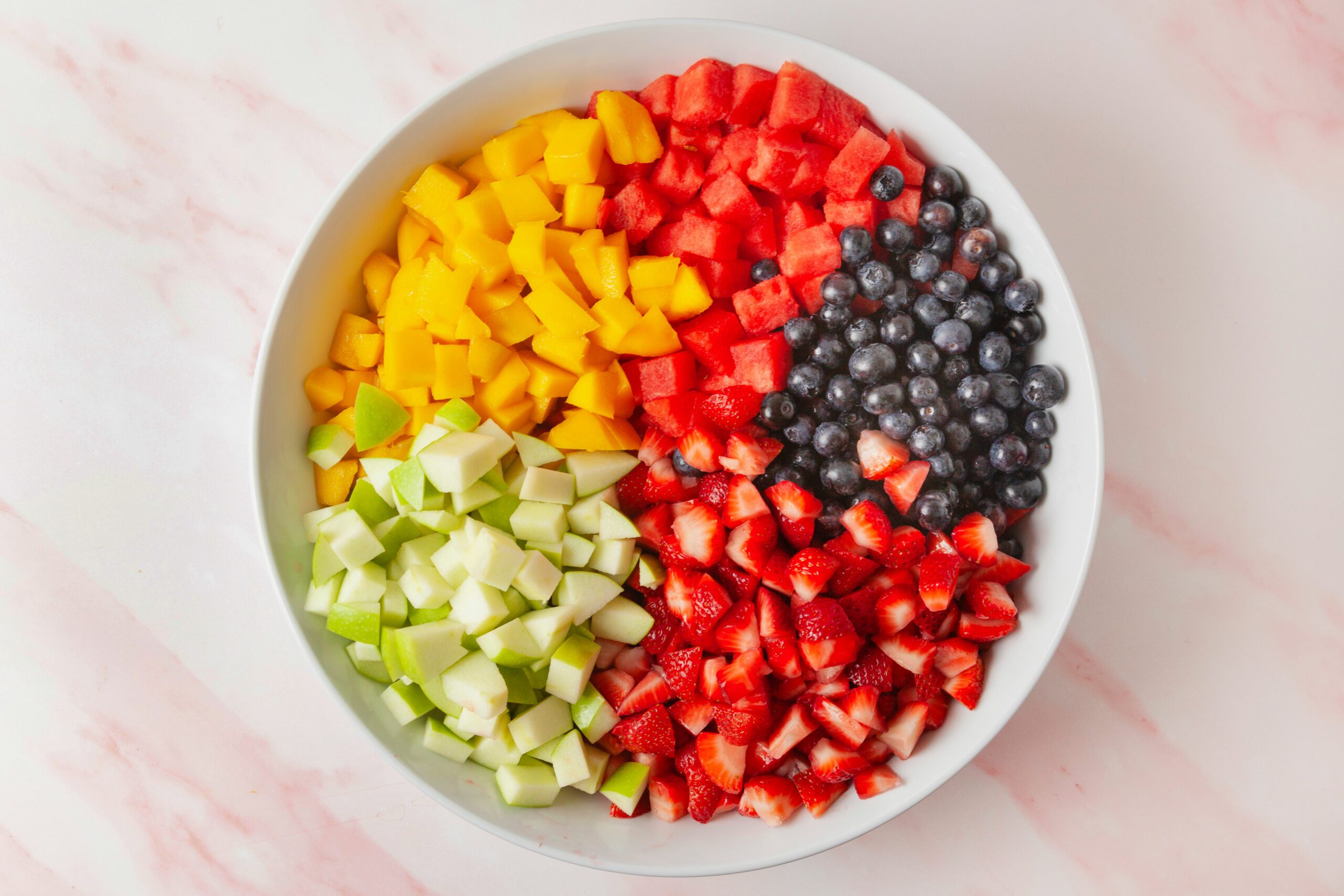strawberries, blueberries, apple, watermelon and mango into similarly-sized small cubes