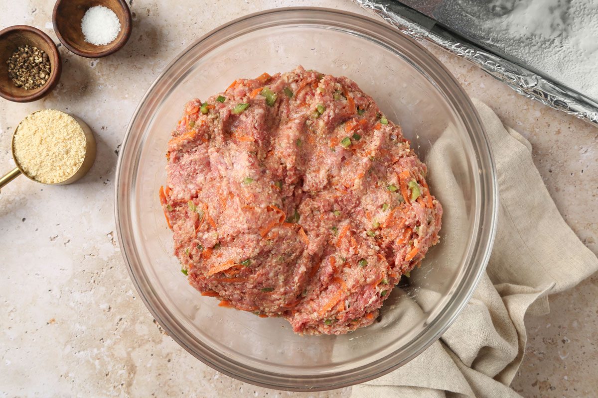 bison meat added to mixture of bread crumbs, milk, poblano pepper, carrots, onion, egg, Worcestershire sauce, salt, pepper, ground mustard, sage, celery salt and garlic powder in a large bowl.