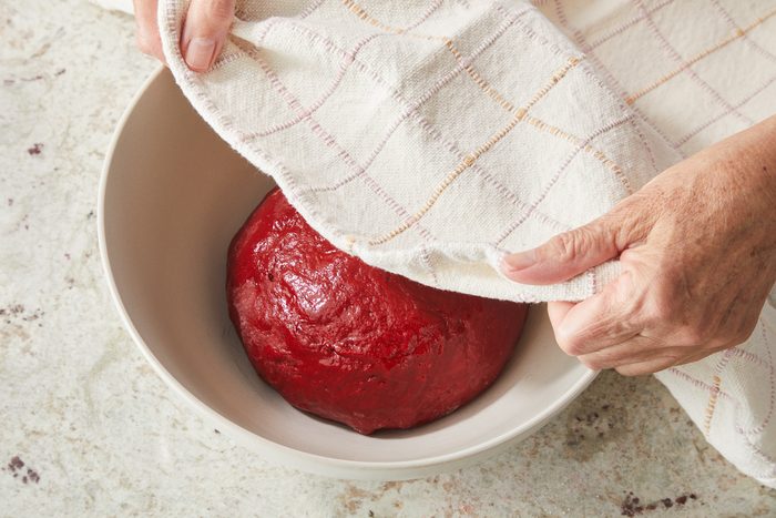 dough in a greased bowl being covered