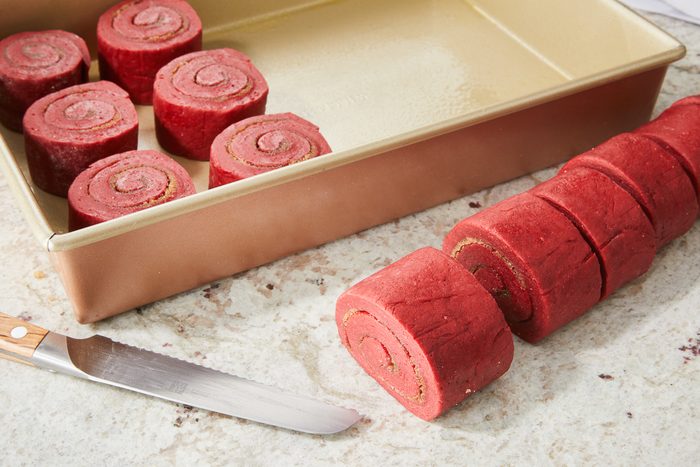 dough cut crosswise and placed in baking pan