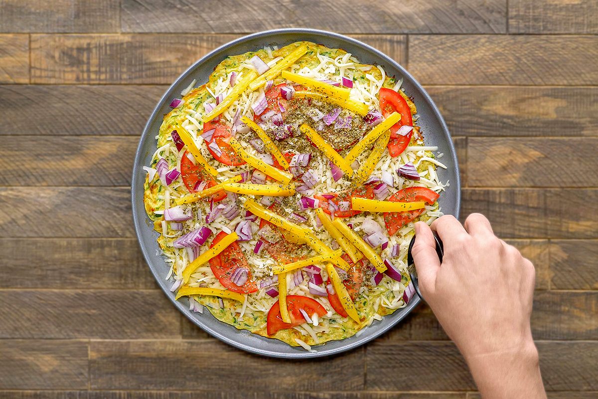 Top the pizza with herbs and remaining Parmesan cheese