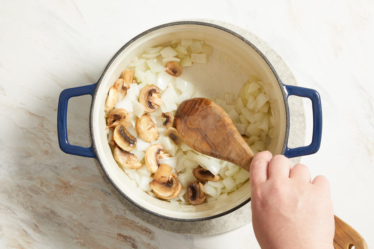 sautéing onions and mushrooms in a saucepan