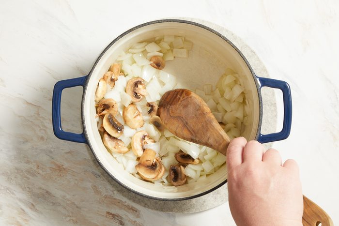 sautéing onions and mushrooms in a saucepan