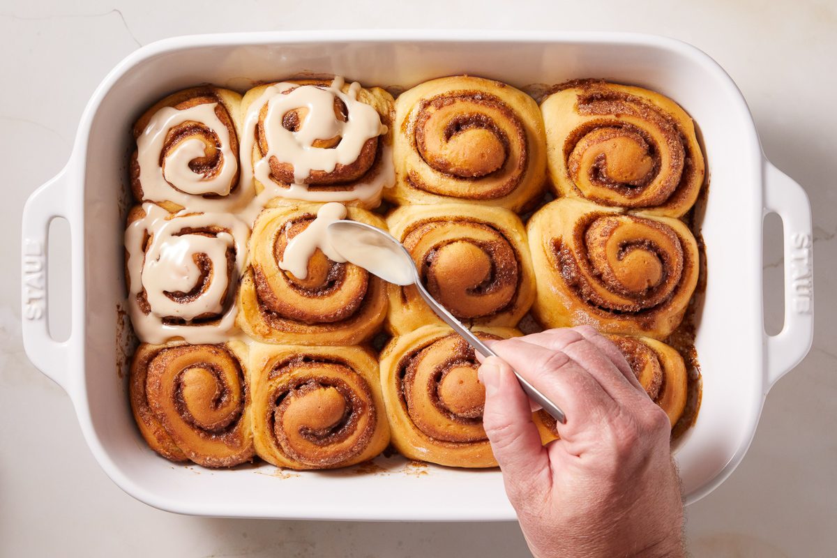 drizzling espresso glaze on rolls