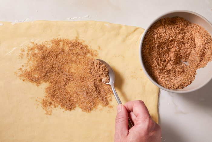 sprinkling chai filling on dough