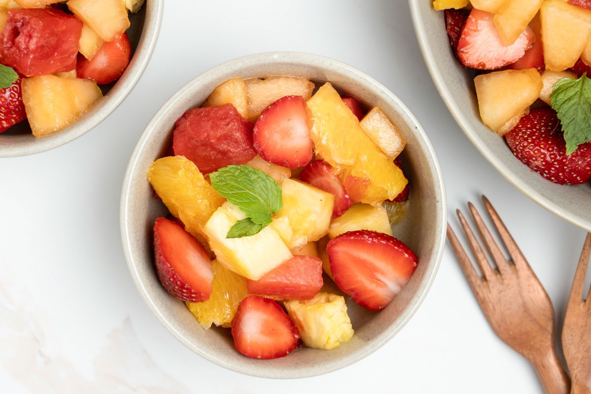 Overhead shot of Fresh Fruit Bowl garnished with mint leaves