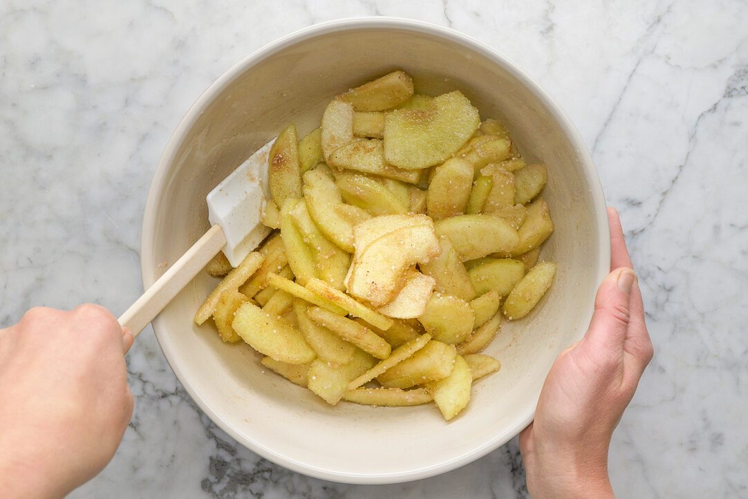 apples, sugar, water, tapioca, cinnamon and nutmeg combined in a bowl