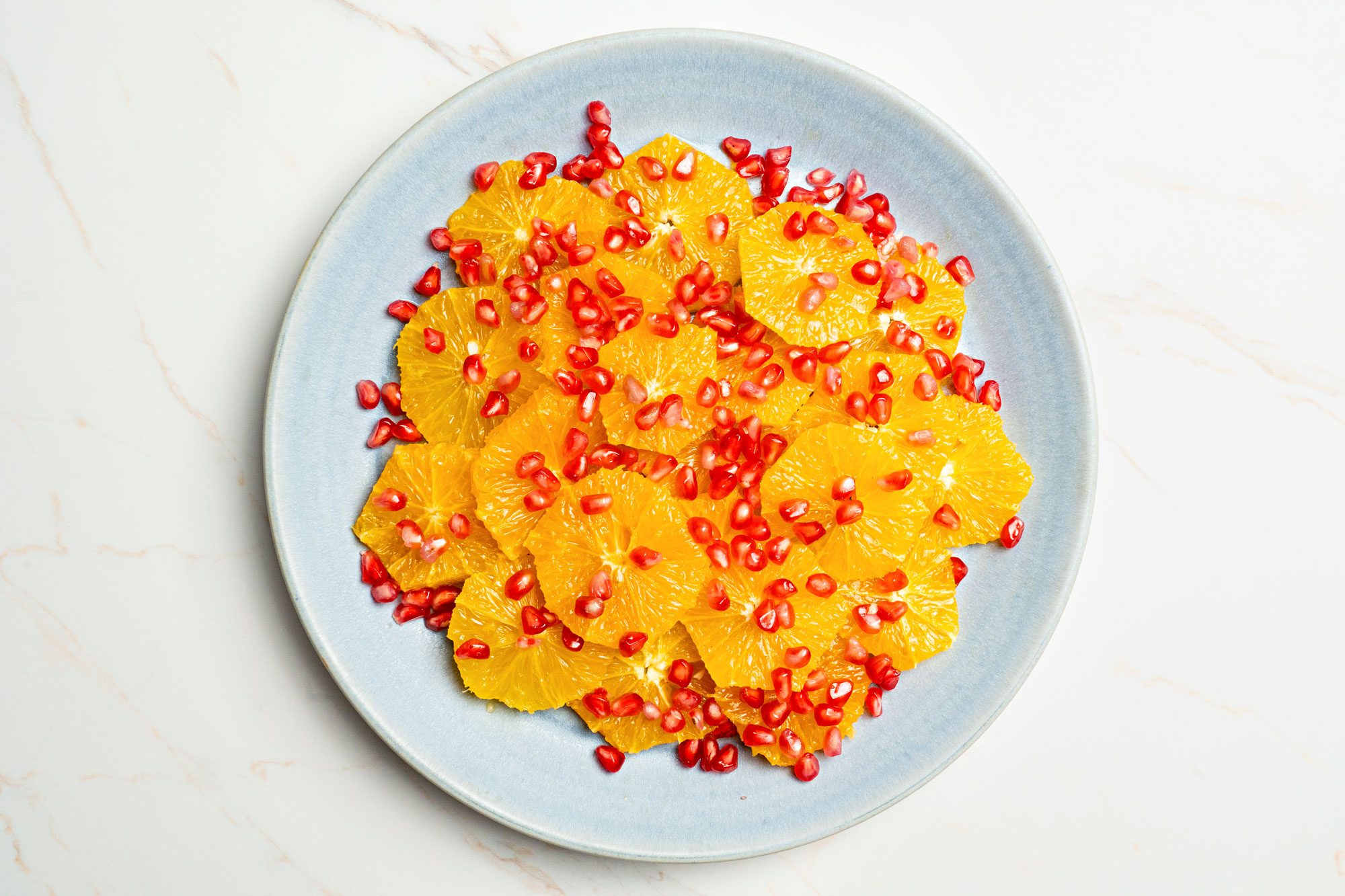 Arrange orange slices on a serving platter; sprinkle with pomegranate seeds.