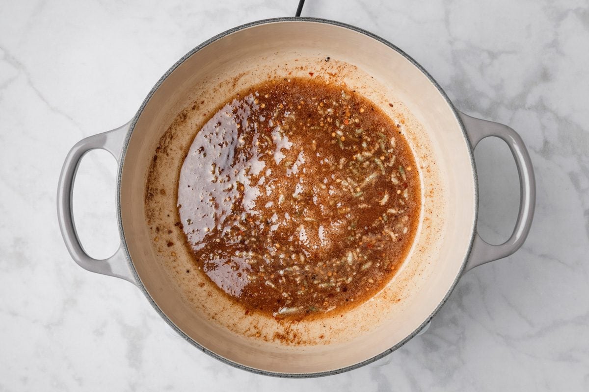 sugar, cider vinegar, minced garlic, ground ginger, ground cumin, ground cinnamon, crushed red pepper flakes and ground cloves mixed in a large saucepan