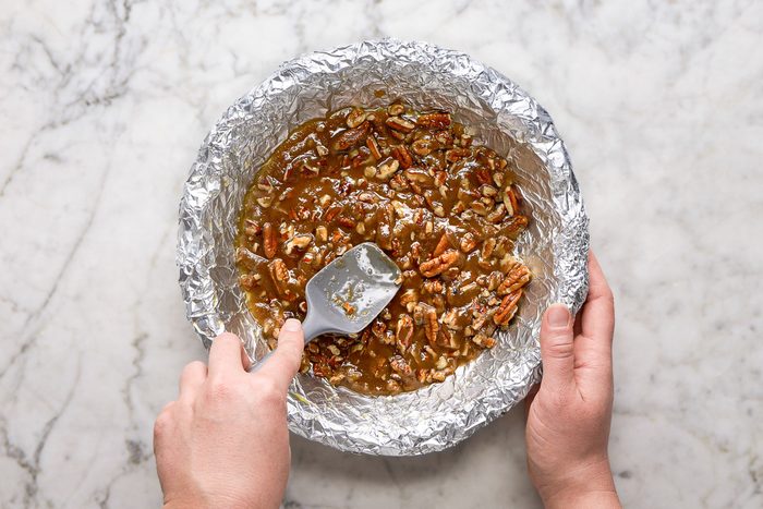 Spooning pecan mixture into foil-lined plate