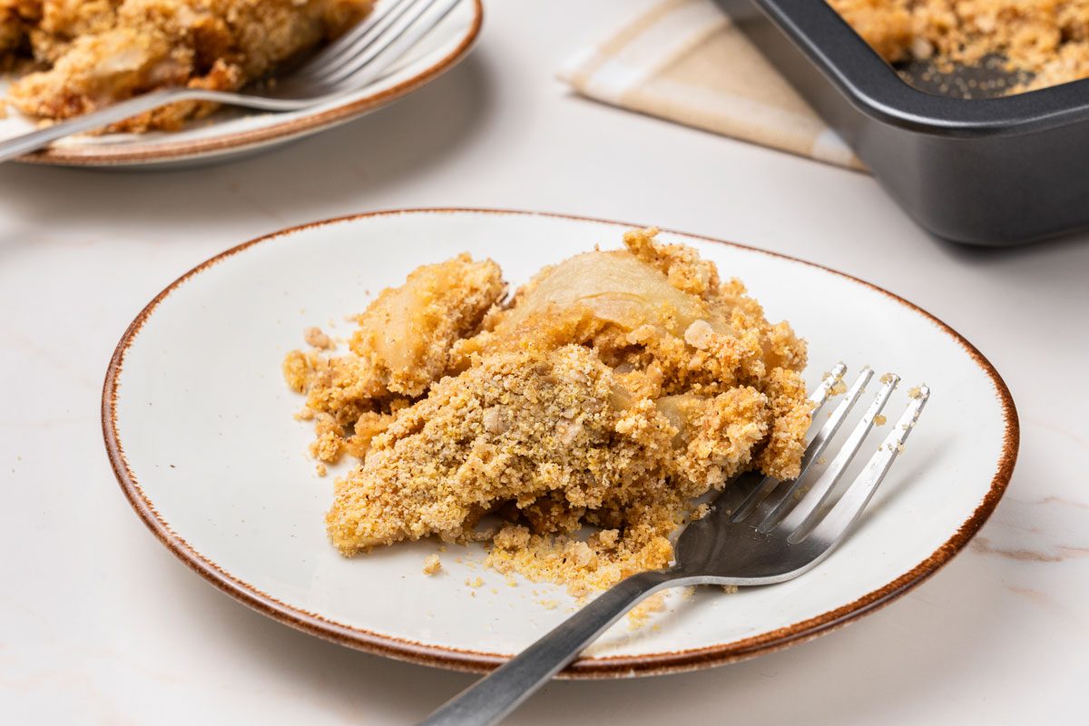 3/4 shot of Apple Cornbread Crisp served on a plate with fork