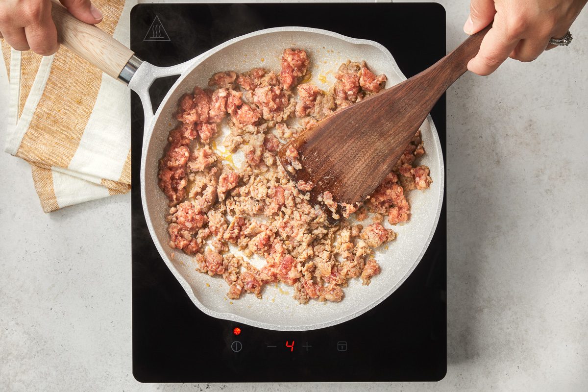 cooking sausage in a skillet
