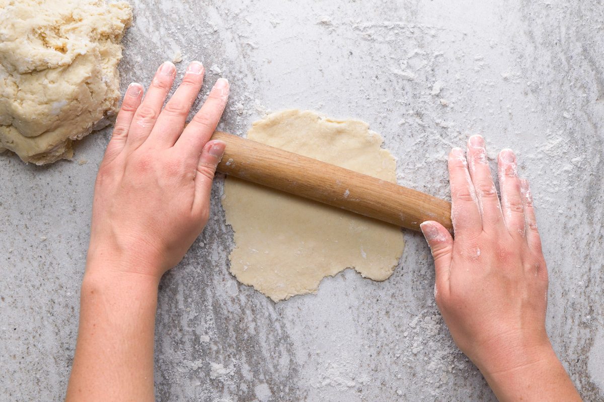 rolling dough out into 5 inch circle