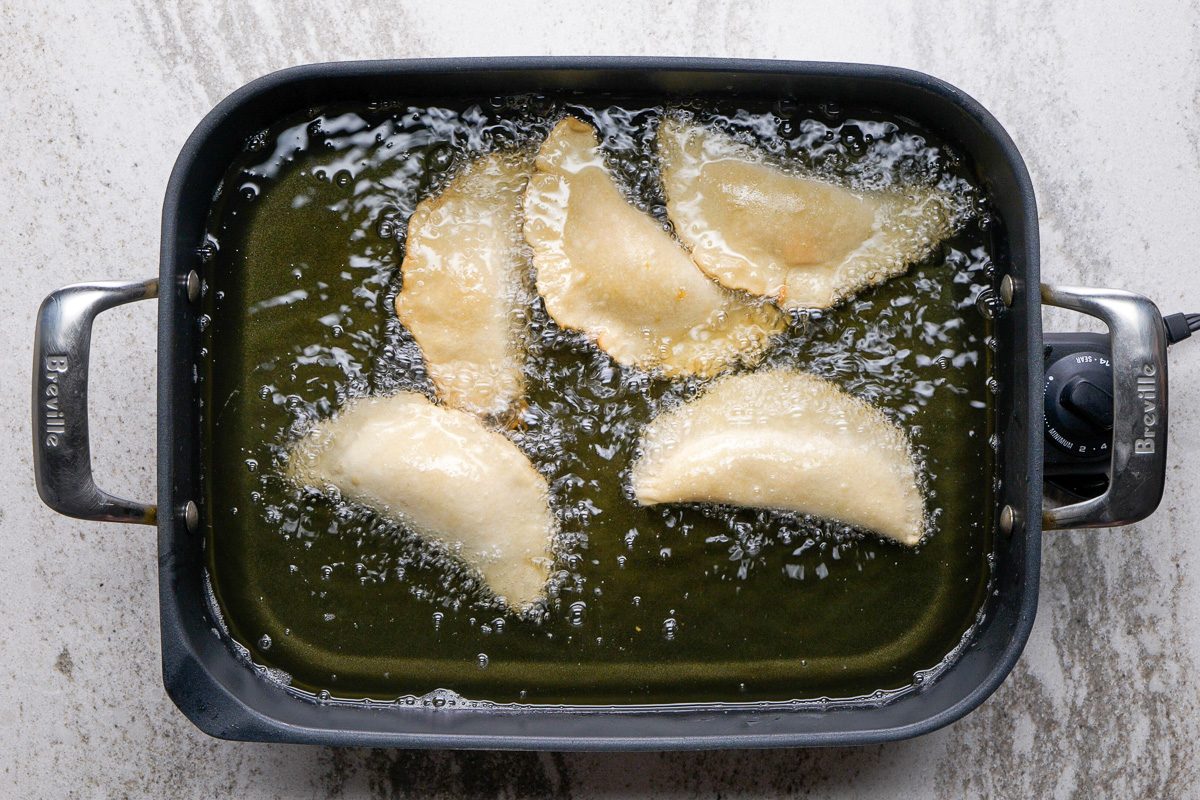 pies being fried in a skillet