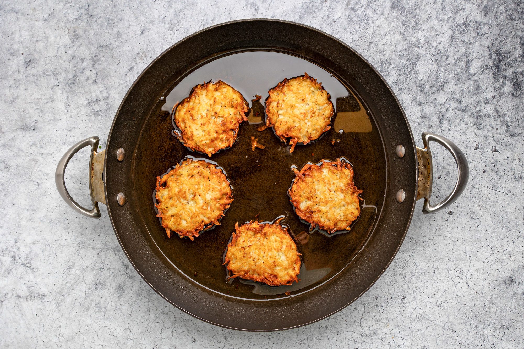 In a large skillet, heat 1/4 in. oil over medium heat. Drop batter by 1/4 cupfuls; press lightly to flatten.