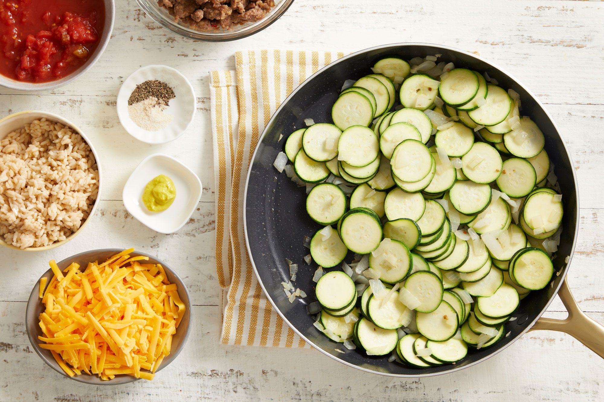 Add zucchini and onion; cook and stir until tender.