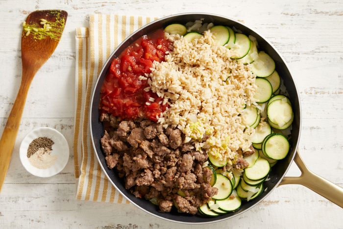Stir in sausage, tomatoes, rice, mustard, garlic salt and pepper.
