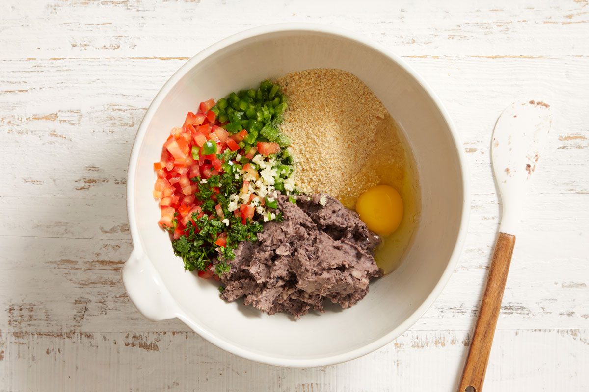 Transfer beans to a large bowl. Add bread crumbs, tomato, jalapeno, egg, cilantro and garlic. Mix until combined.