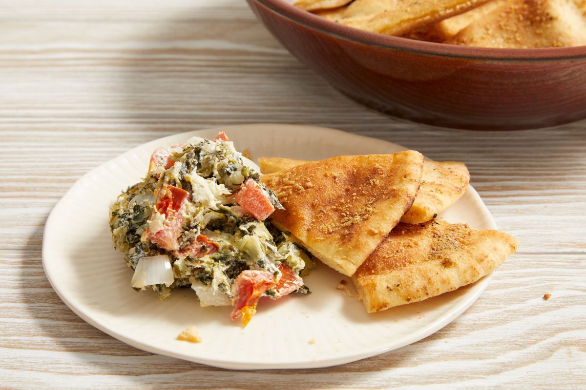 Close up shot of Hot Spinach Spread with Pita Chips