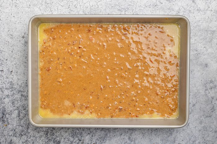 batter poured over melted butter in the pan and spread into an even layer