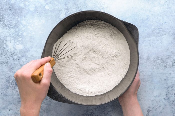 all-purpose flour, sugar, baking soda, salt, cinnamon, nutmeg, baking powder and cloves being whisked together in a bowl