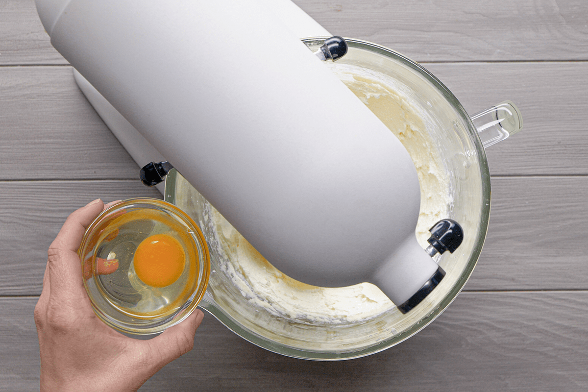 Adding eggs to flour