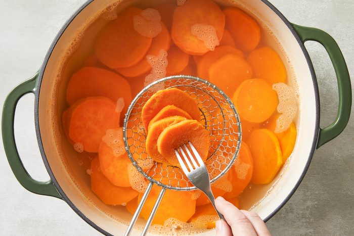 draining potatoes out of dutch oven
