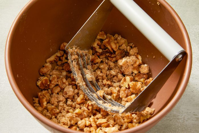 walnuts, brown sugar and cinnamon being combined in a small bowl