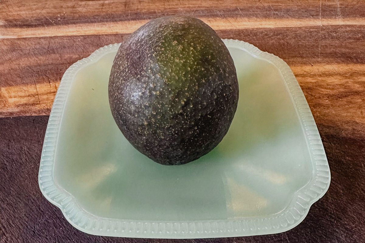 sliced avocado upside down on a plate