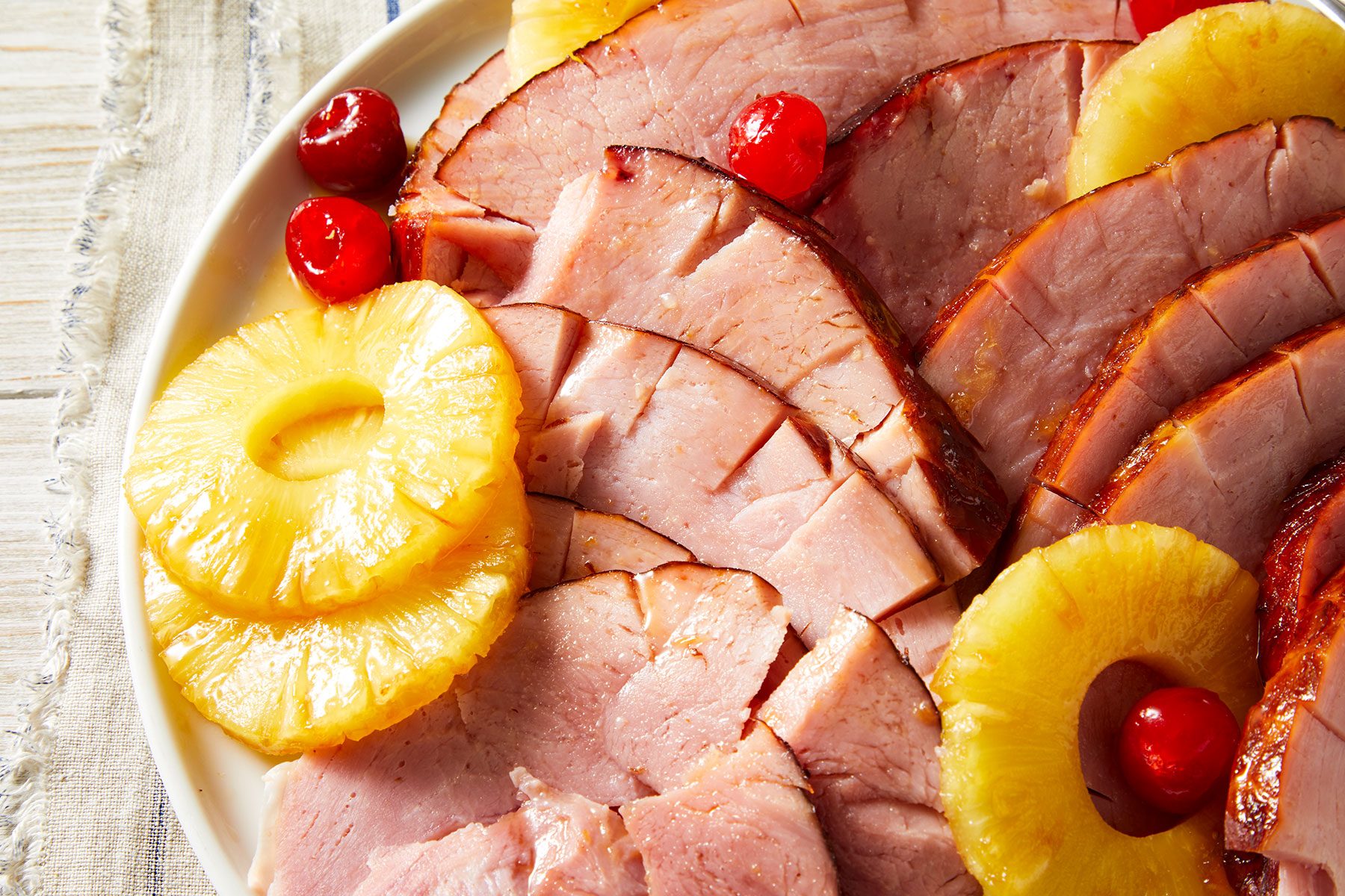 Baked Ham With Pineapple cut into pieces and served on a plate.