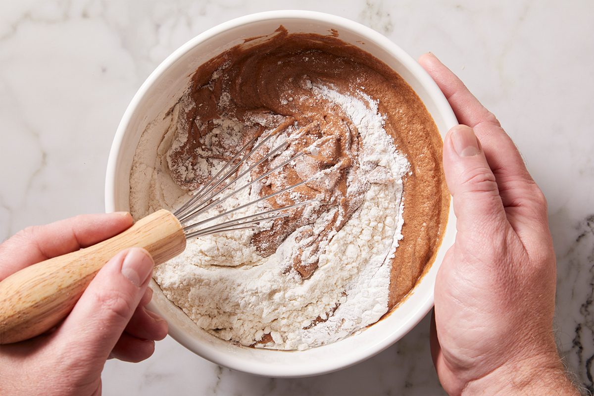 Whisking all purpose flour with brownie batter 