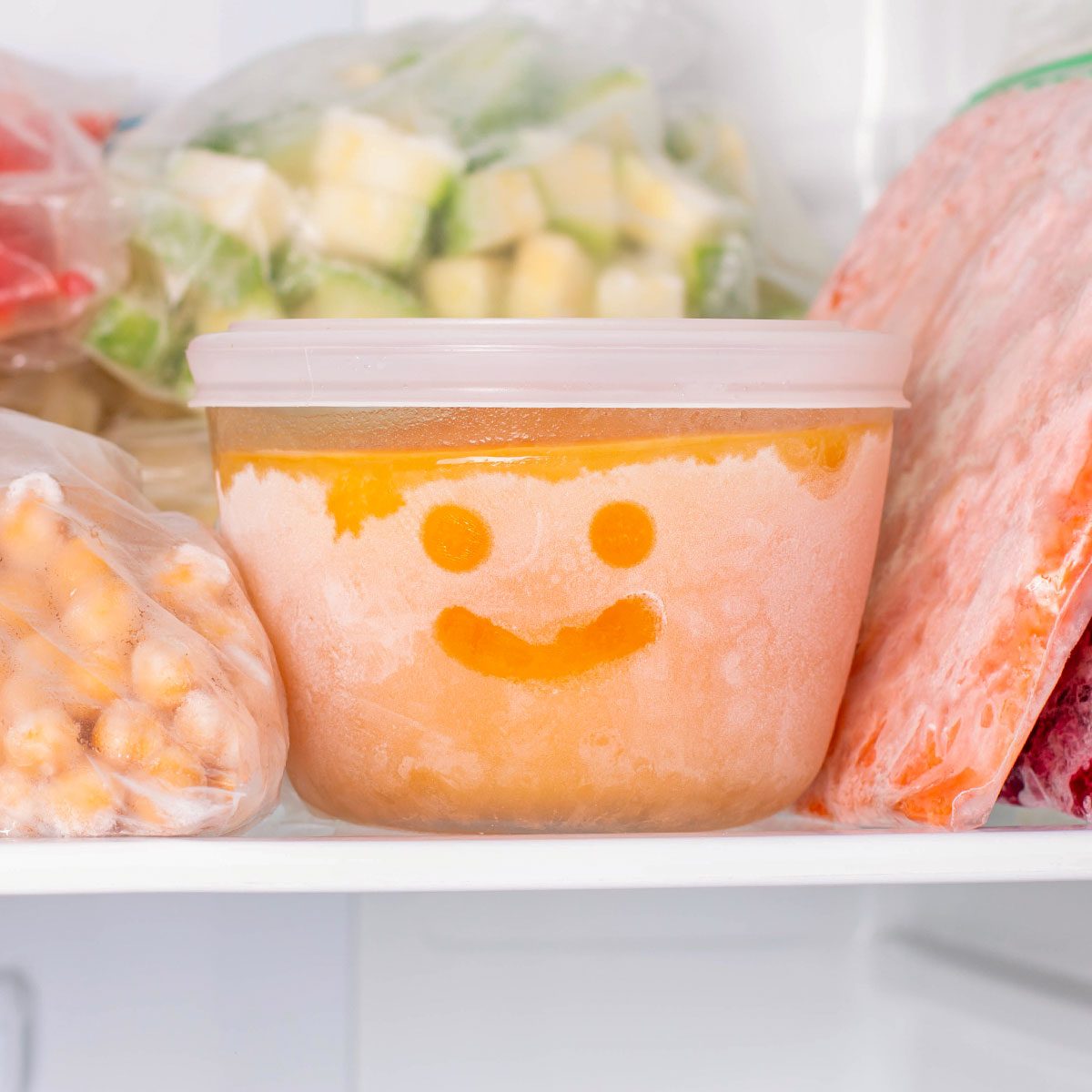 Frozen food in the freezer. Frozen vegetables, soup, ready meals in the freeze