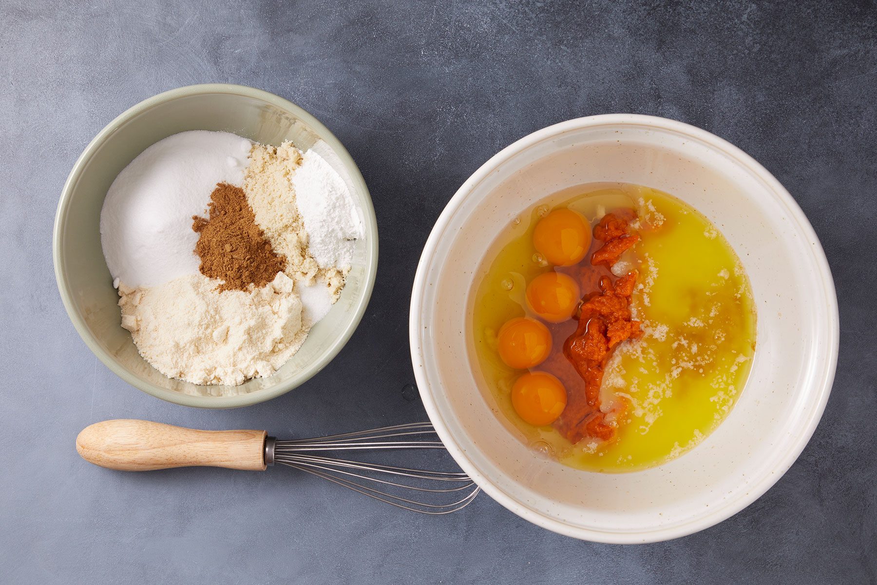 Dry and wet ingredients in separate bowls to make Keto Pumpkin Muffins.