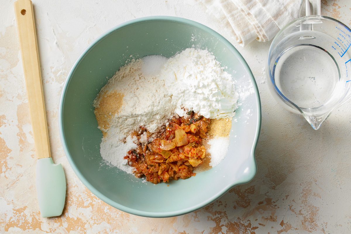 chopped kimchi, flour, cornstarch, sugar and baking powder in a bowl